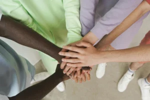 A blog post photo showing hands of various races, color.